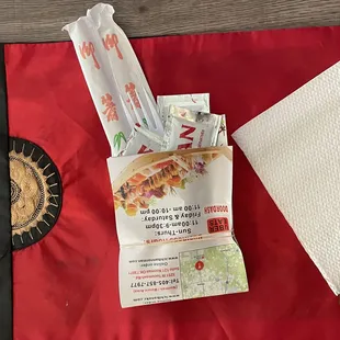 I love the takeout packet with utensils and condiments wrapped in their menu!