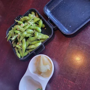 a bowl of green beans and a plate of rice