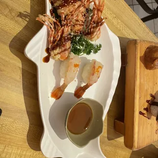 Am 56. Ebi Nigiri served with tonkatsu sauce.