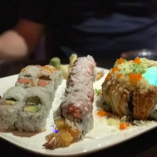 a plate of sushi and rolls