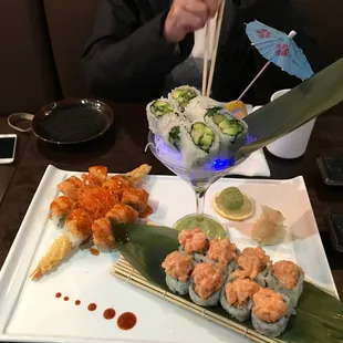 a plate of sushi and a cocktail