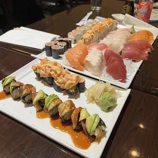 a variety of sushi on a white plate