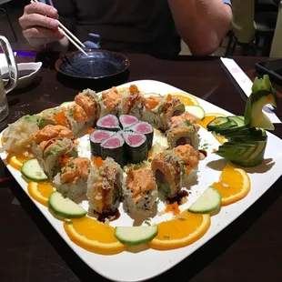 a plate of sushi and vegetables