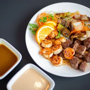 a plate of food and a bowl of sauce