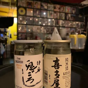 two jars of sake on a table