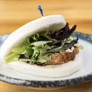 a pork bun with lettuce