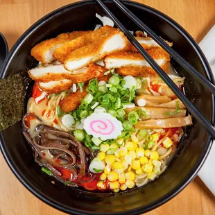 a bowl of ramen with chopsticks