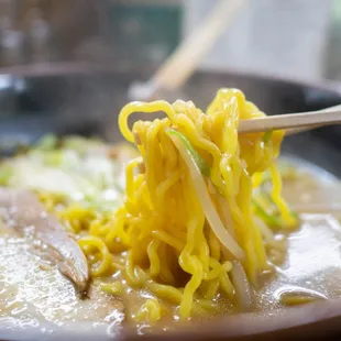 a bowl of ramen with chopsticks