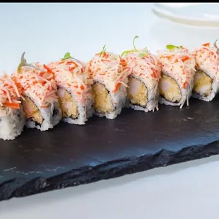 American dream Roll 
Crispy coconut shrimp inside, top with crabmeat mix with Japanese Mayonnaise and premium flying fish egg. Mango sauce