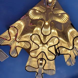 a light fixture made of paper strips