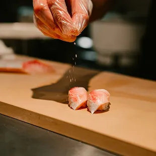 a person preparing food on a cutting board