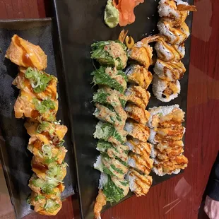 two plates of different types of sushi
