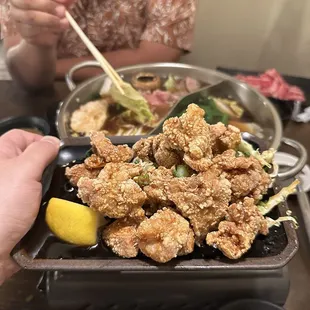 a person eating a meal with chopsticks