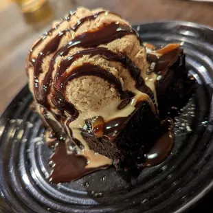 a chocolate dessert with ice cream and chocolate sauce