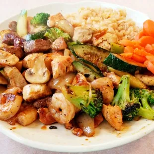 Hibachi Trio (Chicken, Shrimp, Steak) with Fried Rice, Mixed Vegetables and Sweet Carrots.