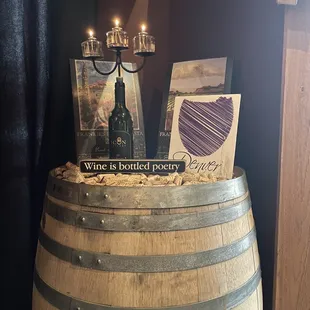 a wine barrel with a candle and wine bottle