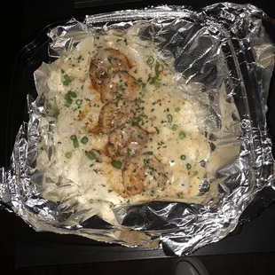 a meal of mashed potatoes, meatballs, and gravy