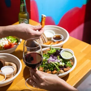 two people clinking glasses of wine