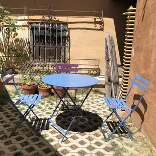 a patio with a table and chairs