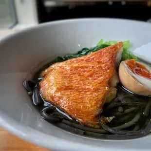 TOKYO KINMEDAI RAMEN in tomato-seafood broth with squid ink noodles and soy marinated egg from April Le Fruits De Mer Menu