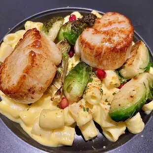 Scallops with brussels sprouts, pomegranate seeds, and togarashi-squash pasta