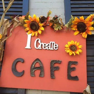 a sign with sunflowers on it