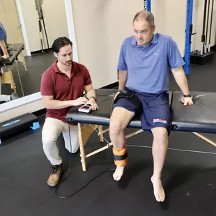 physical therapist helping patient with leg pain