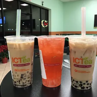 three drinks on a table in a restaurant