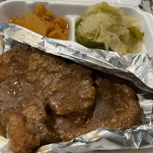 Smothered pork chops, candied yams, cabbage