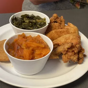 a plate of fried chicken and vegetables