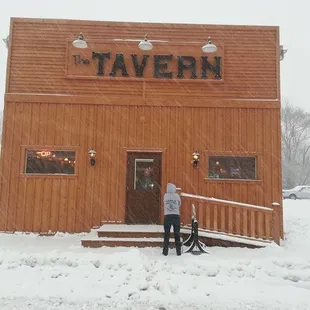 two people standing outside in the snow