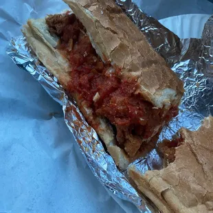 a sandwich with meat and tomato sauce