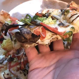 No nonsense Deep dish pizza slice.. Ample toppings and decent amount of cheese. Hand for scale