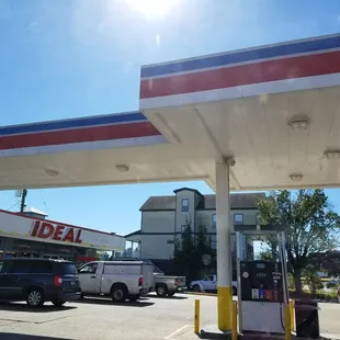 a gas station with cars parked in the lot