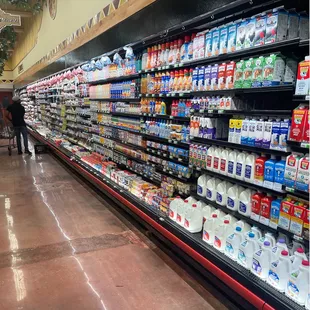 a grocery aisle with milk and milk products
