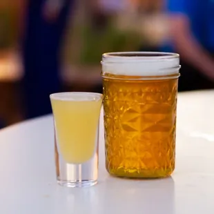 a glass of beer and a jar of honey