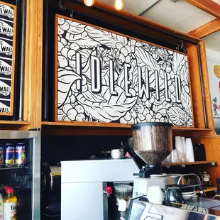 a sign above a coffee machine