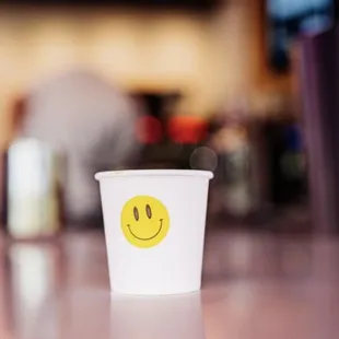 a cup with a smiley face on it