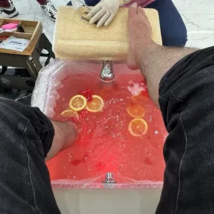 Relaxing foot spa with added orange slices