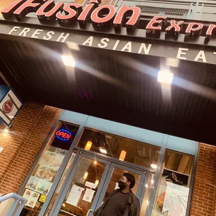 a woman walking out of a restaurant