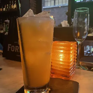 a glass of orange juice on a table