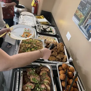 Noodles, chicken, shoyu pork, maki sushi, and andagi.