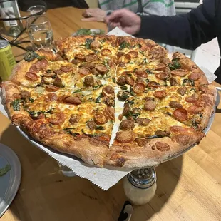 pepperoni, spicy sausage, spinach, and caramelized onion pizza.