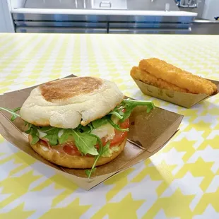 Iggycado - jammy egg, avocado, greens, tomato, iggy sauce on an English muffin  And hashbrowns