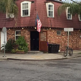 a brick building with an american flag on it