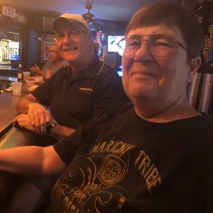 a man and a woman sitting at a bar