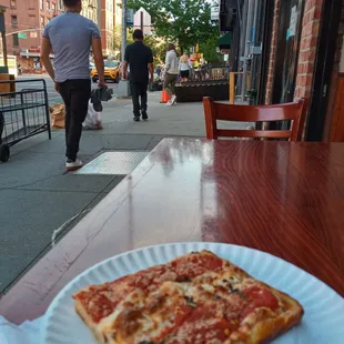 Square slice at an outside table on First Avenue $3.75