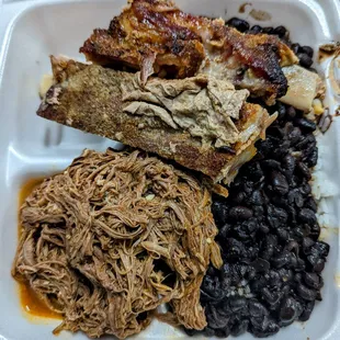 Braised beef with ribs. Side of black beans and white rice.