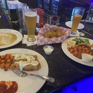 Fish &amp; chips with tots, lake Perch with tots, fried pickles, empty plate from Calamari and a Dirty Blonde and Blue Moon beer