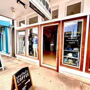 a sign in front of a coffee shop